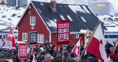 Citizens of Greenland protest the Greenland transatlantic crisis, holding a sign that reads “Greenland is not for sale” during a rally in Nuuk.