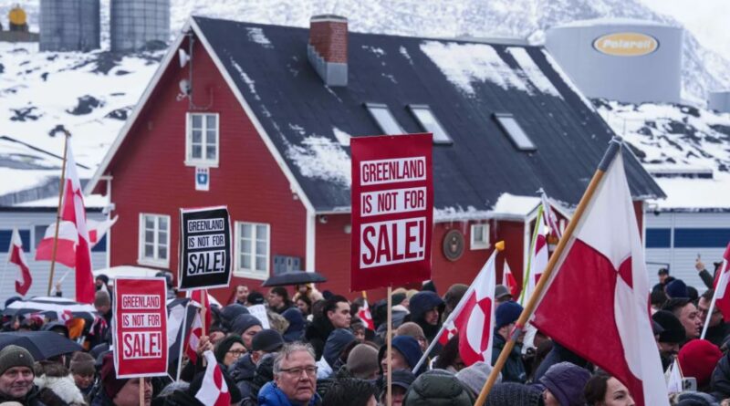 Citizens of Greenland protest the Greenland transatlantic crisis, holding a sign that reads “Greenland is not for sale” during a rally in Nuuk.